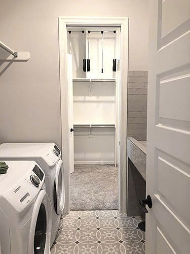 A white laundry room with a washer and dryer.